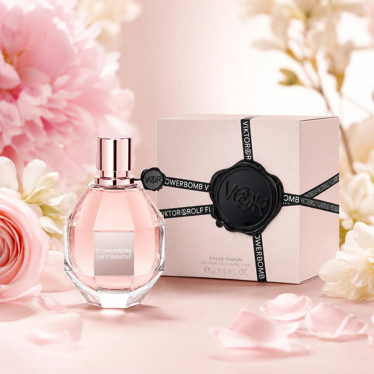 Viktor & Rolf Flowerbomb EDP 30ml women's perfume hero image with the faceted pink bottle and box styled with soft pink flowers and petals.