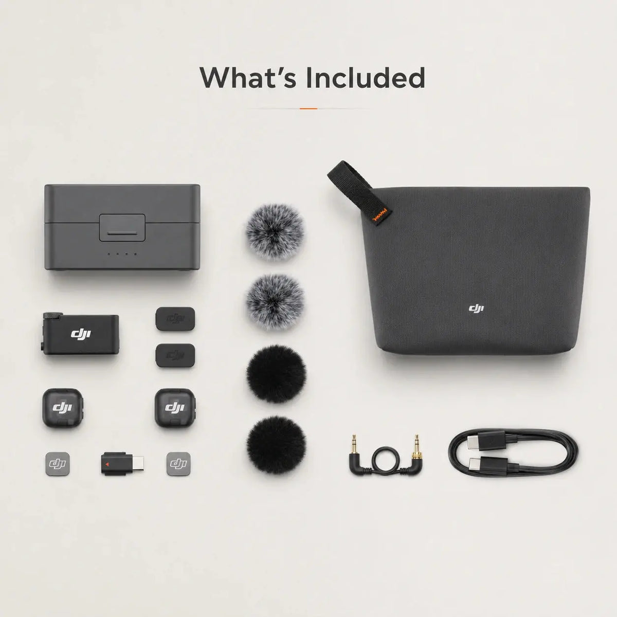 Collection of DJI accessories including a case, microphone, and cables on a light gray background.