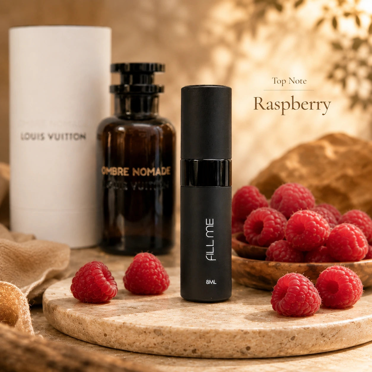 Louis Vuitton Ombre Nomade 8ml decant top note image highlighting raspberry with the Fill Me atomiser and full-size fragrance shown behind.