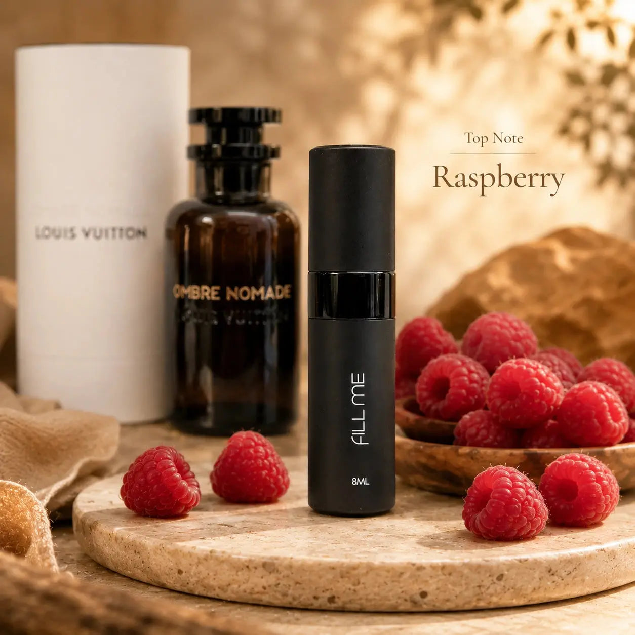 Louis Vuitton Ombre Nomade 8ml decant top note image highlighting raspberry with the Fill Me atomiser and full-size fragrance shown behind.