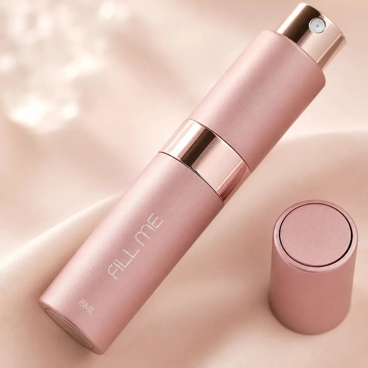 Fill Me refillable 8ml travel perfume atomiser bottle pink close-up detail image highlighting the matte finish, spray nozzle and rose gold centre band
