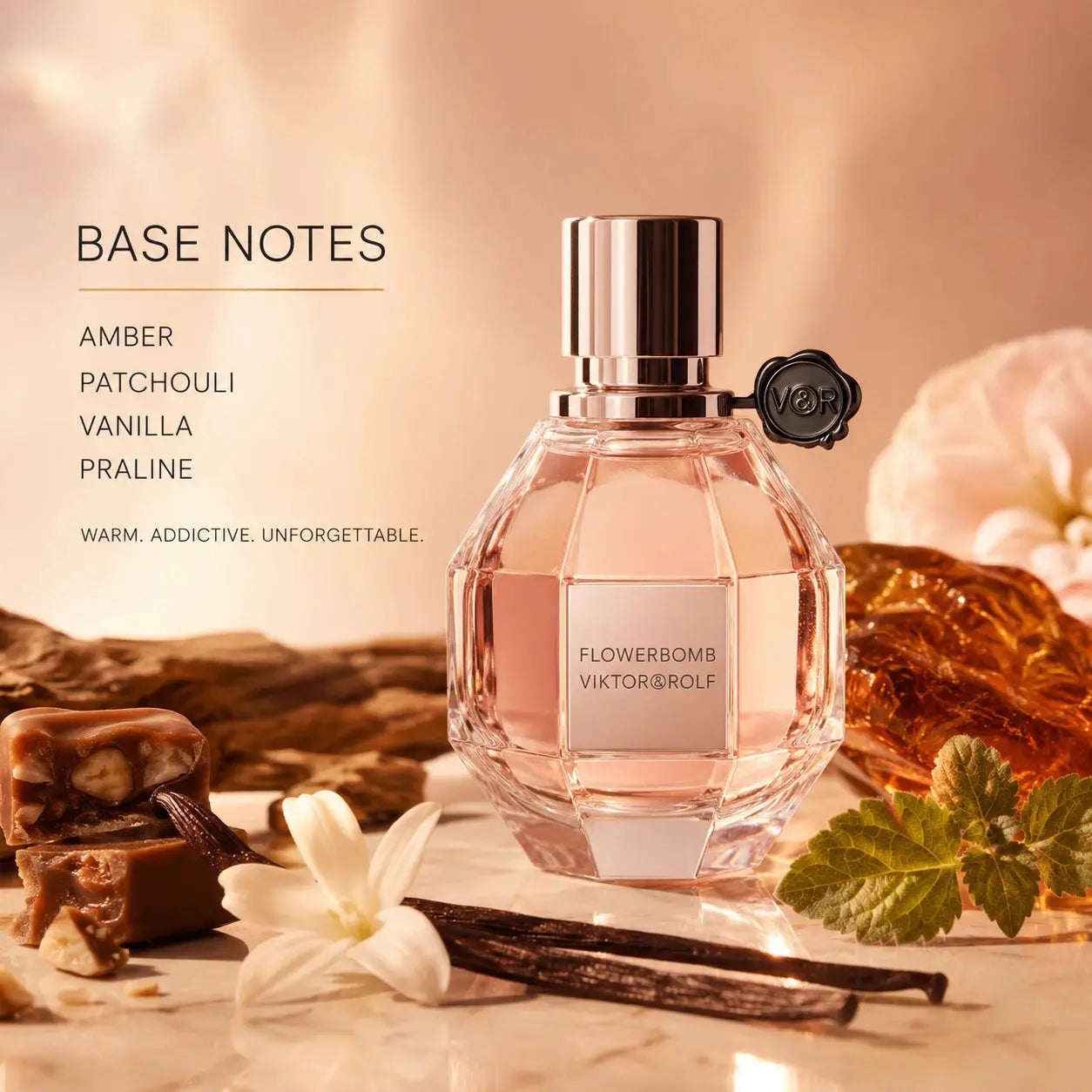 Viktor & Rolf Flowerbomb 50ml EDP base notes image with amber, patchouli, vanilla and praline styled around the Flowerbomb bottle.