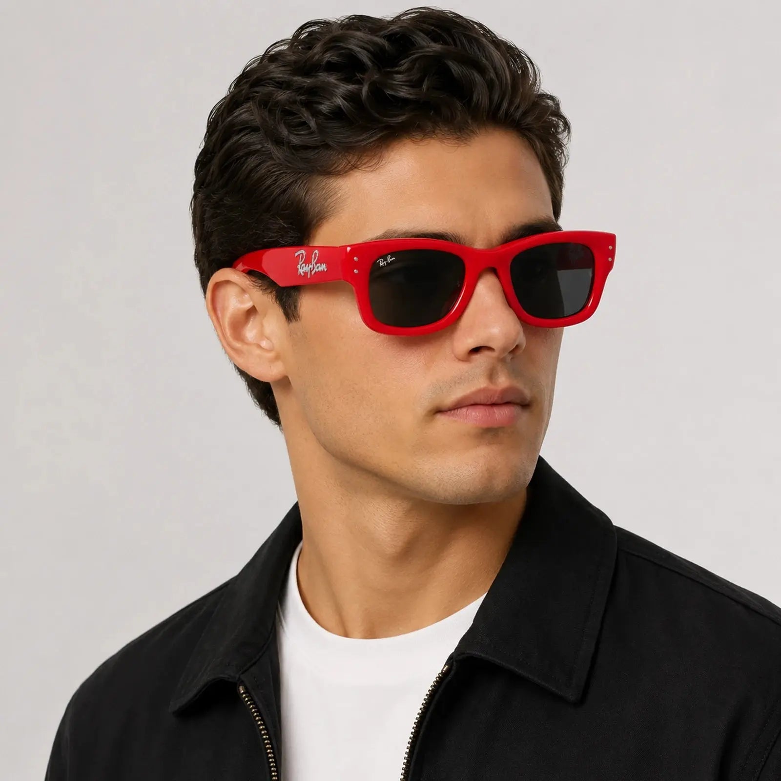 Man wearing red sunglasses with a neutral background