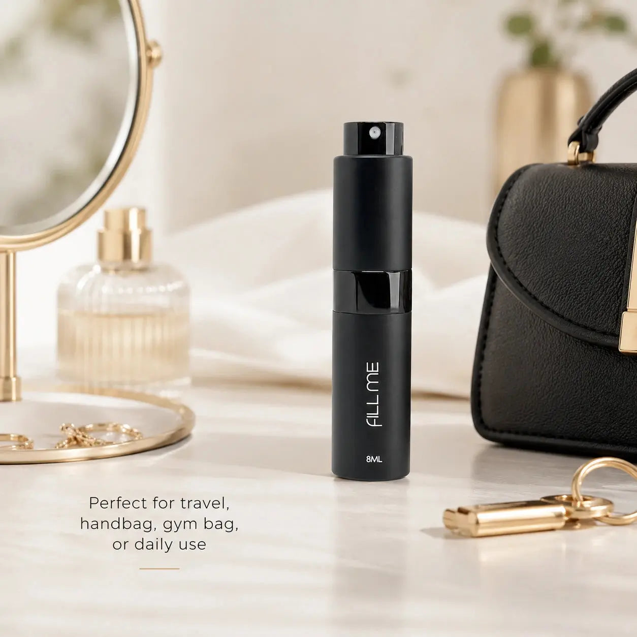 Fill Me refillable 8ml travel perfume atomiser bottle black premium lifestyle image styled beside a mirror, handbag, and vanity accessories.