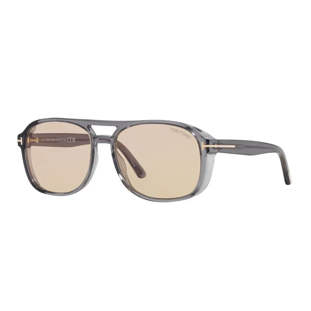 Tom Ford FT1022 Rosco sunglasses featuring a translucent grey acetate square frame. The brown photochromic lenses are paired with the signature gold 'T' logo at the temples.
