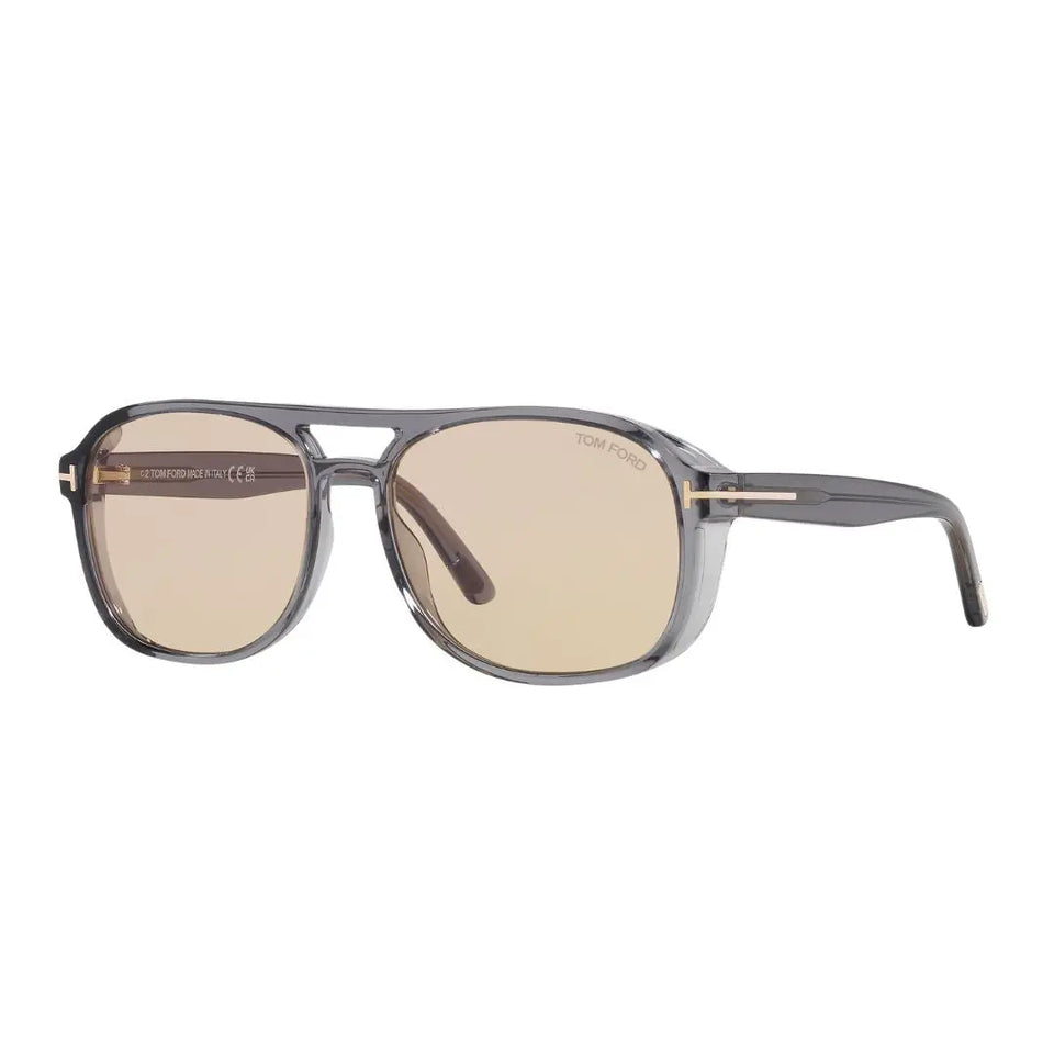 Tom Ford FT1022 Rosco sunglasses featuring a translucent grey acetate square frame. The brown photochromic lenses are paired with the signature gold 'T' logo at the temples.