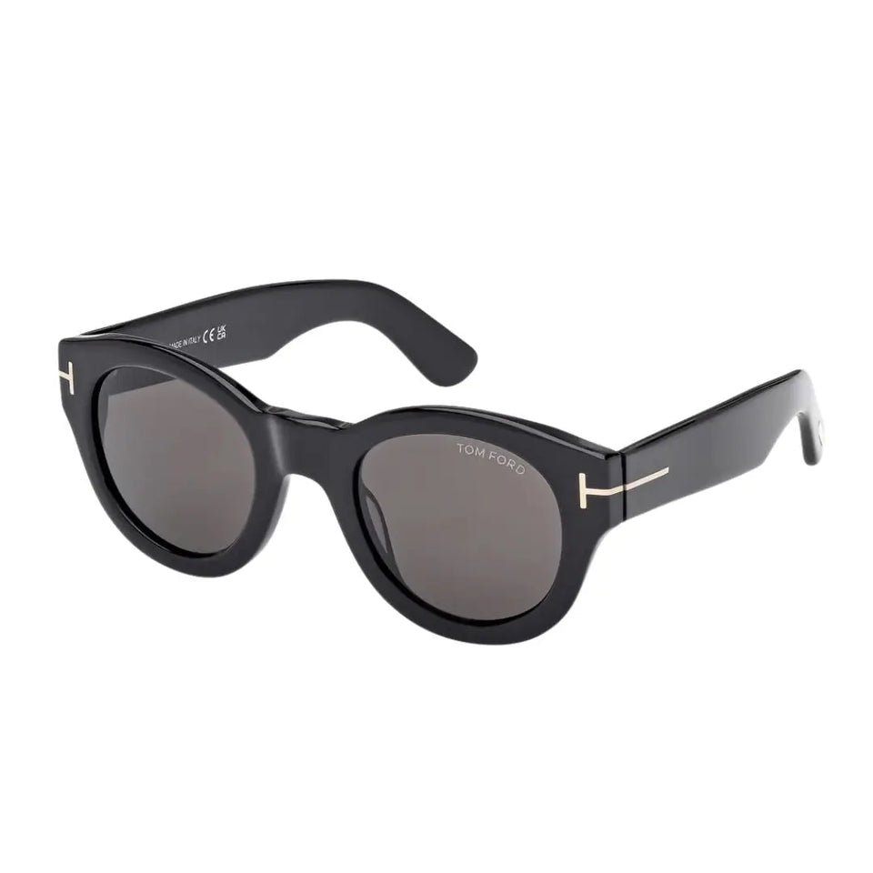 Tom Ford FT1212 Lucinda unisex sunglasses featuring a vintage-inspired round shiny black acetate frame. The smoke grey lenses are accented by the signature gold 'T' temple logo.