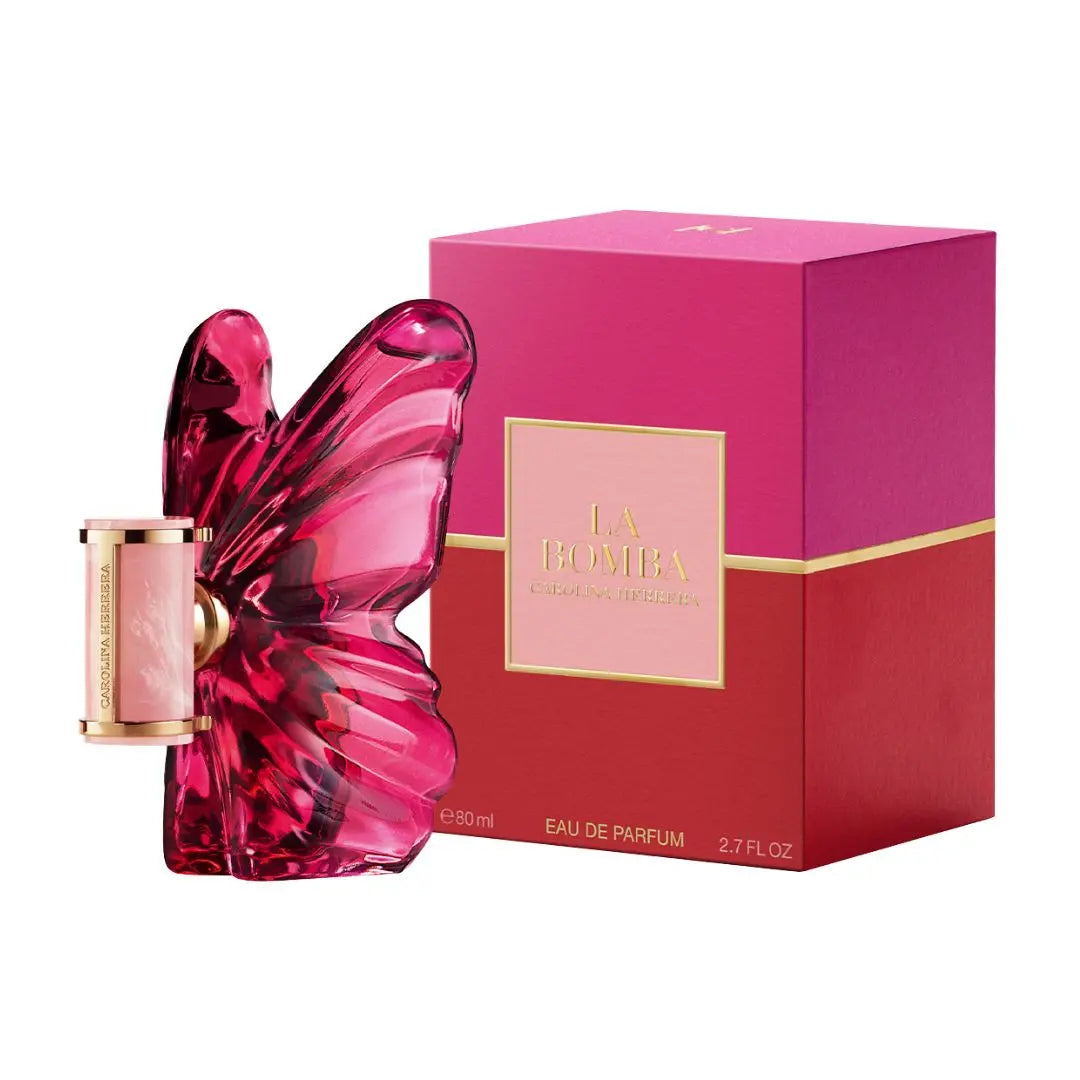 La Bomba Eau de Parfum 80ml bottle with a butterfly-shaped pink glass body, shown next to its pink and red packaging box with gold lettering.
