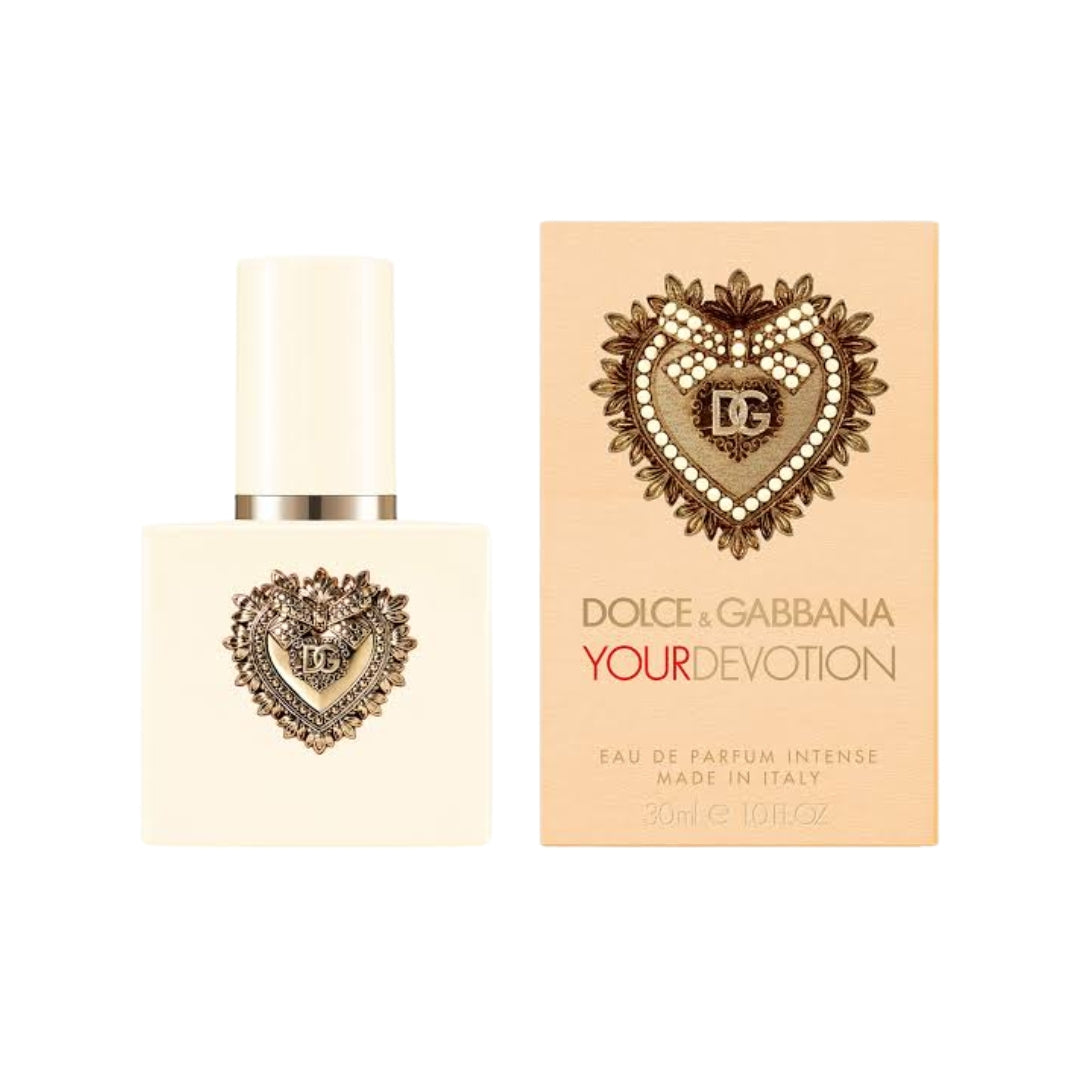 Dolce & Gabbana Your Devotion Eau de Parfum 30ml bottle and its peach-colored packaging box, both featuring an ornate heart-shaped logo with a central 'DG' monogram.