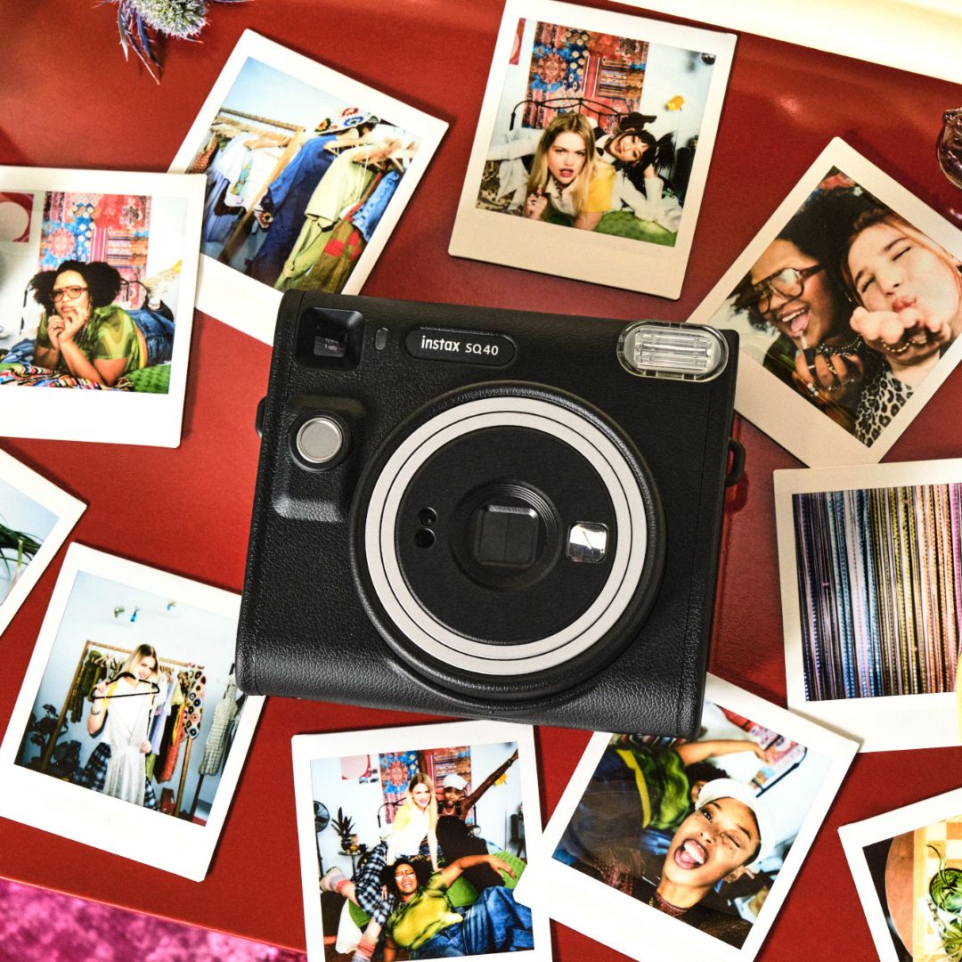 Fujifilm Instax SQ40 Instant camera with instant photos on a red surface