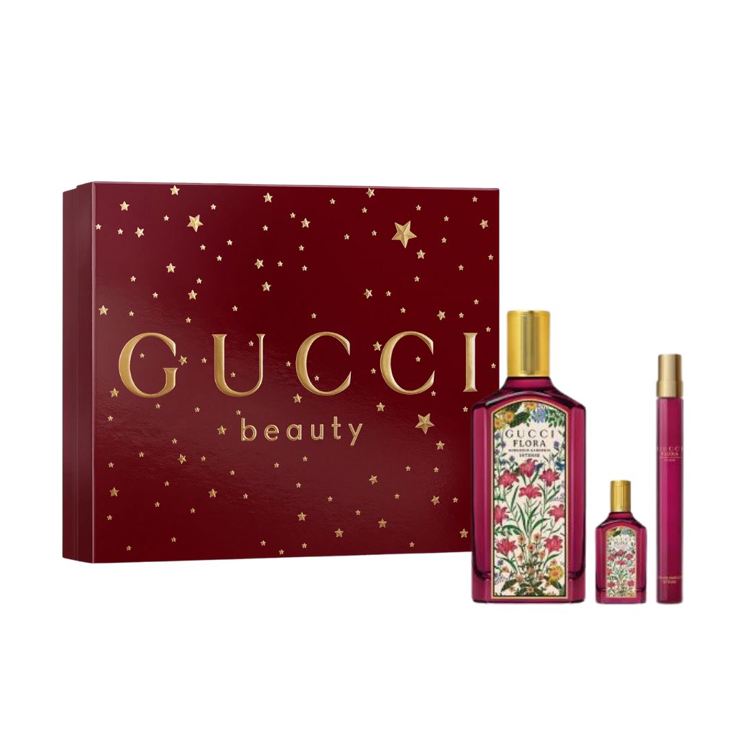 Gucci Flora Gorgeous Gardenia EDP Intense 3pc Gift Set, a vibrant purple floral box containing the iconic purple 100ml bottle, a 10ml pen spray, and a 5ml miniature, suggesting an intensified, rich gardenia floral scent.