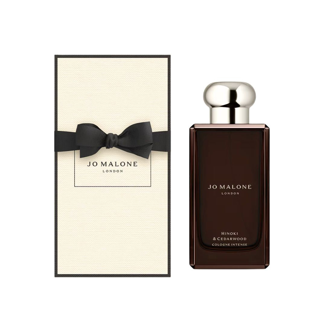 Jo Malone Hinoki & Cedarwood Cologne Intense 100ml, a sleek, dark glass bottle with a minimalist label, suggesting a fresh, woody, and aromatic unisex fragrance.