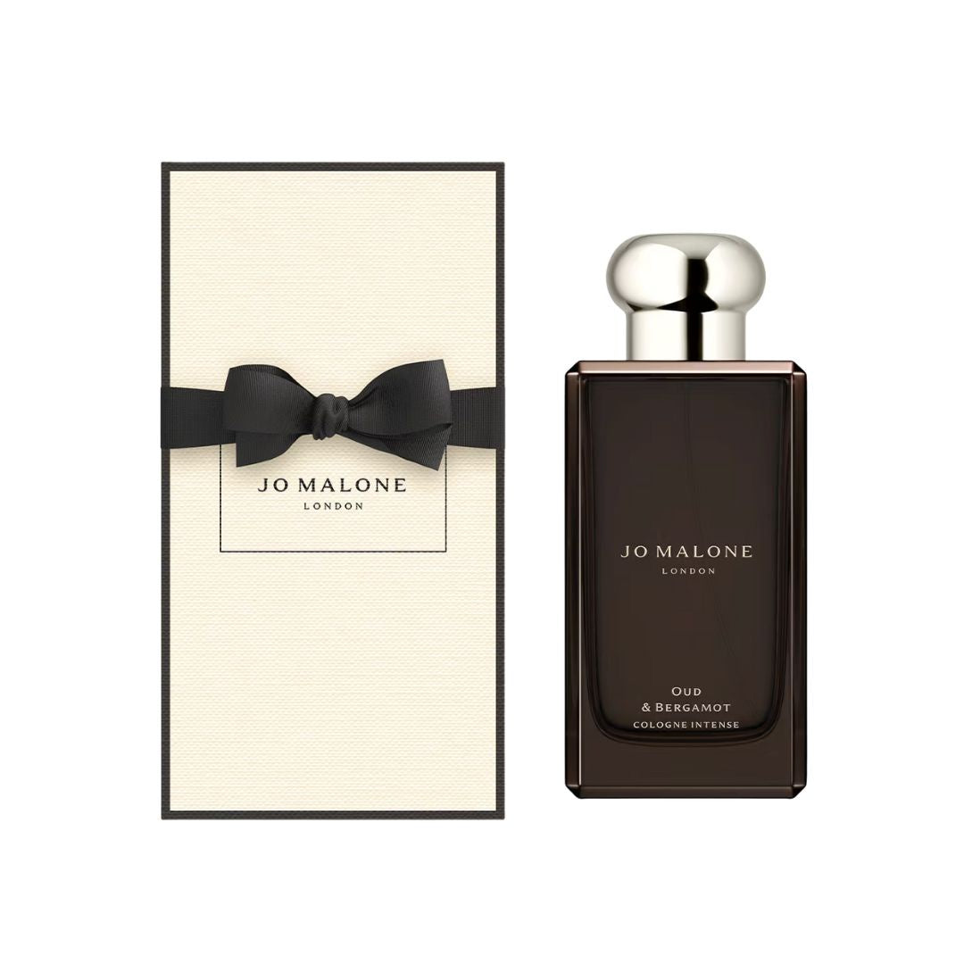 Jo Malone Oud & Bergamot Cologne Intense 100ml, a sleek, dark glass bottle with a minimalist label, suggesting a rich, woody, and luxurious unisex fragrance.