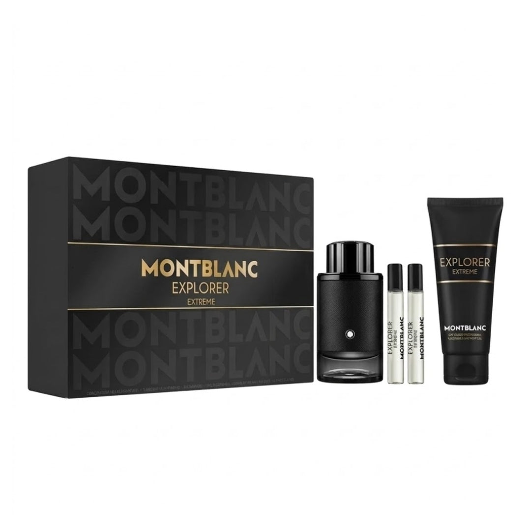 Montblanc Explorer Extreme fragrance gift set featuring a black presentation box, a black perfume bottle, two small travel atomizer vials, and a black body care tube with gold lettering, all on a white background.