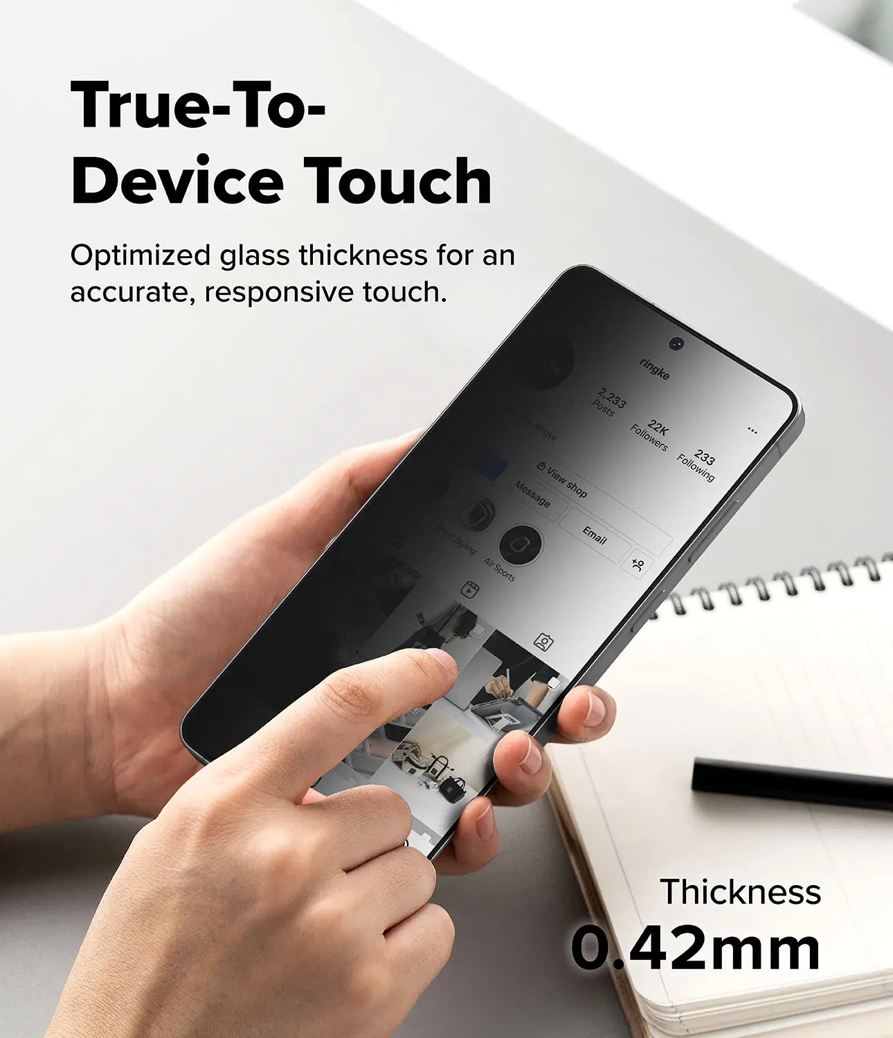 Person holding a smartphone with a screen protector, text about true-to-device touch and glass thickness.