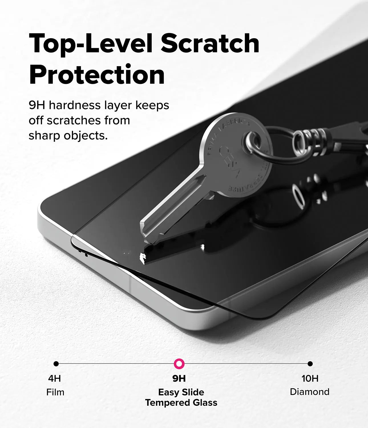 Smartphone with tempered glass screen protector and key on a white background, highlighting scratch protection.