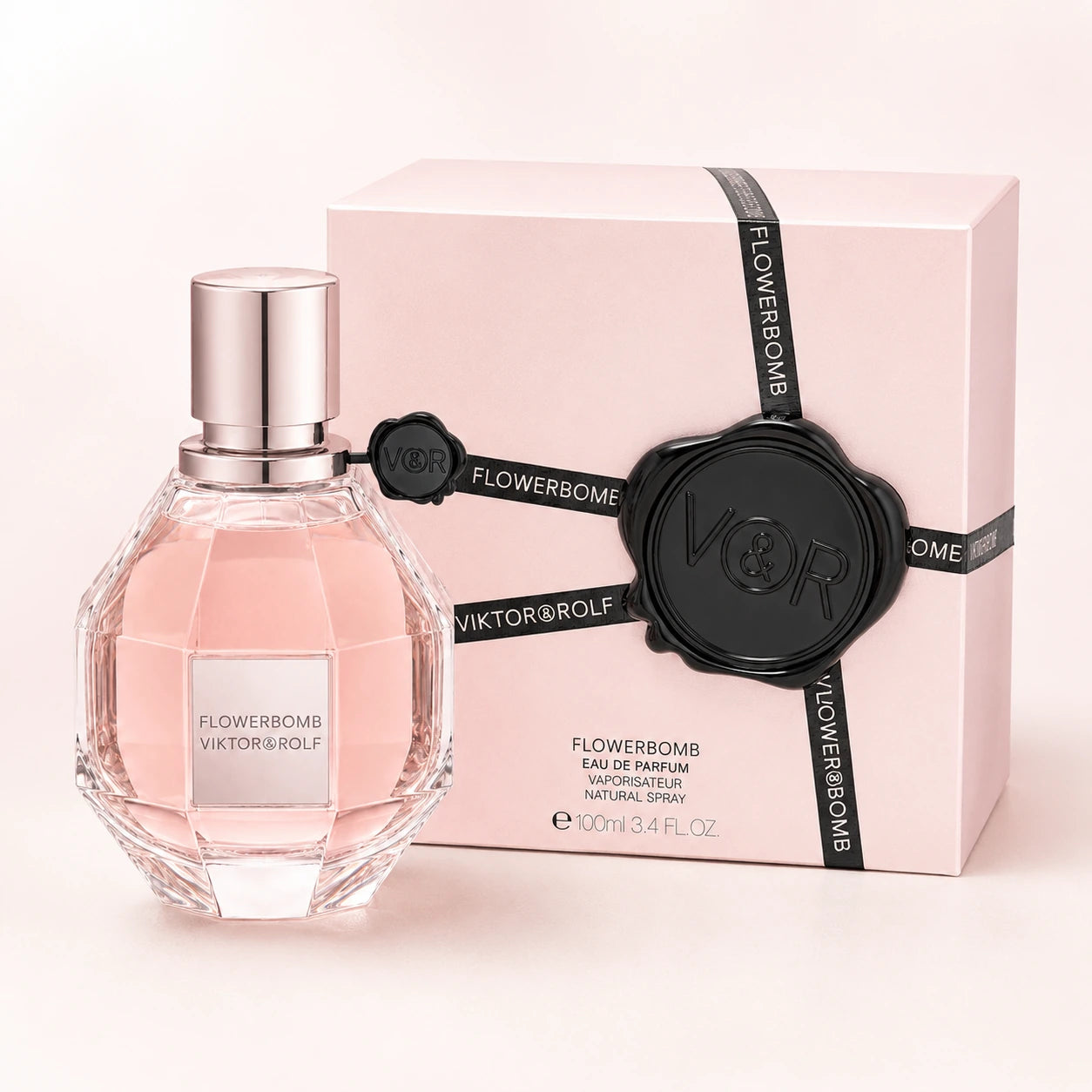 Viktor & Rolf Flowerbomb 100ml EDP women's perfume clean product image showing the original bottle and pink box on a bright studio background.