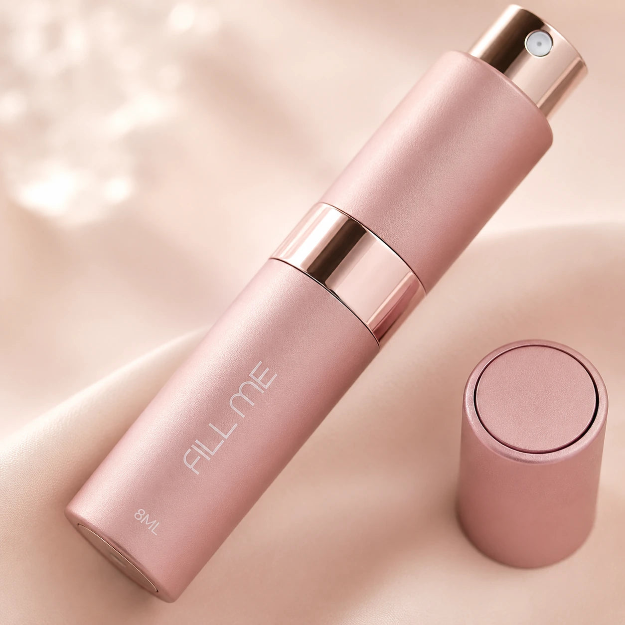 Fill Me refillable 8ml travel perfume atomiser bottle pink close-up detail image highlighting the matte finish, spray nozzle and rose gold centre band
