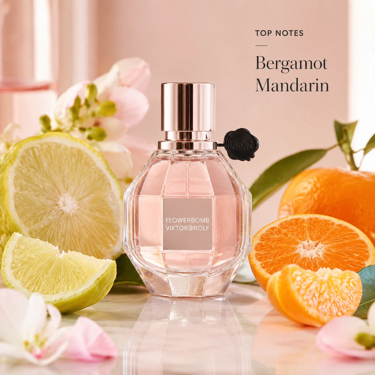 Viktor & Rolf Flowerbomb 50ml EDP top notes image with bergamot and mandarin beside the Flowerbomb bottle in a bright feminine floral setting.