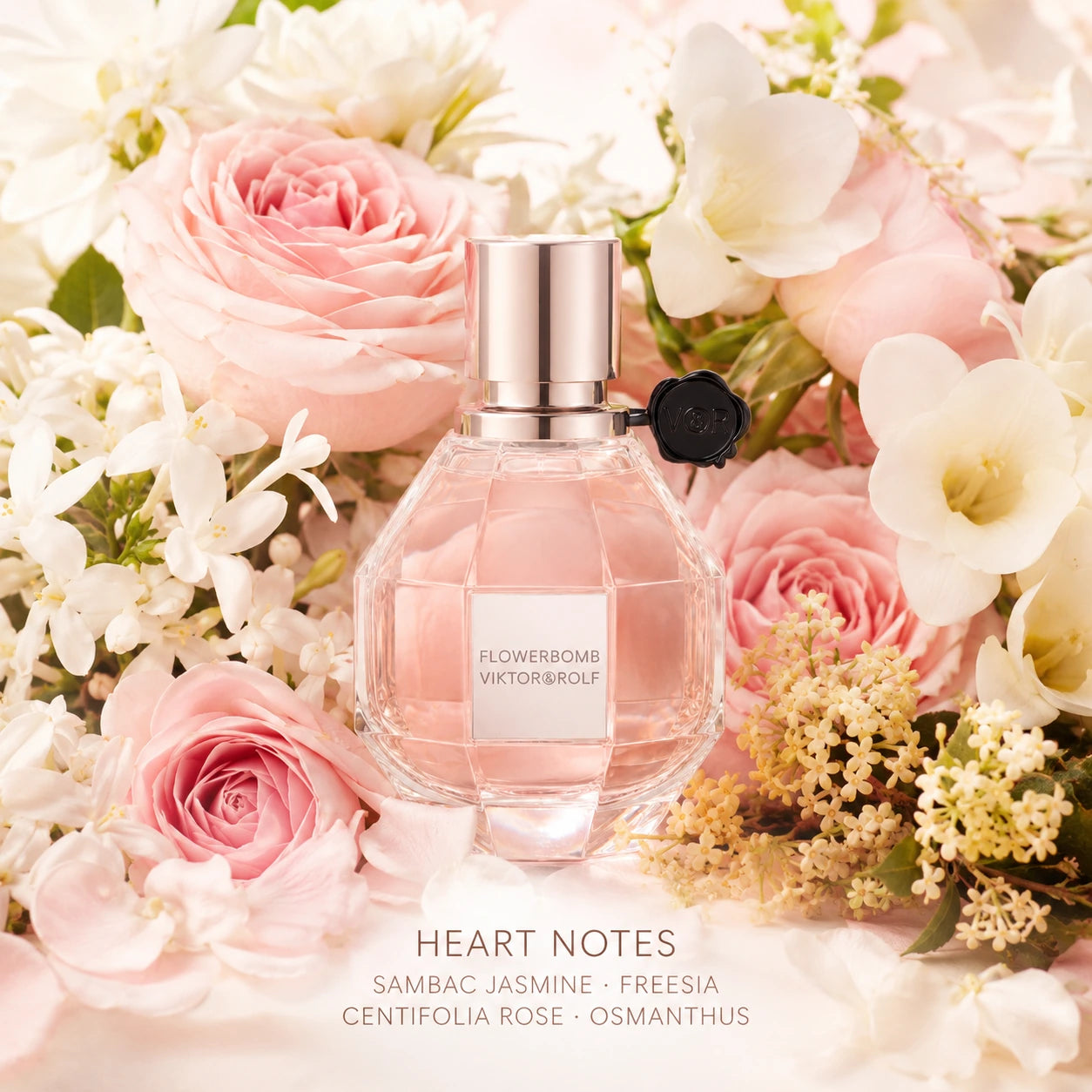Viktor & Rolf Flowerbomb 100ml EDP heart notes image with sambac jasmine, freesia, centifolia rose and osmanthus around the Flowerbomb bottle.