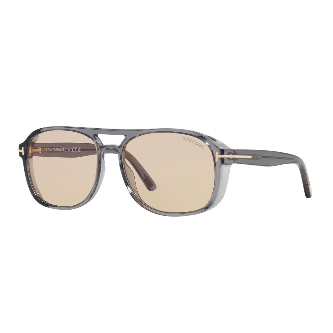 Tom Ford FT1022 Rosco sunglasses featuring a translucent grey acetate square frame. The brown photochromic lenses are paired with the signature gold 'T' logo at the temples.