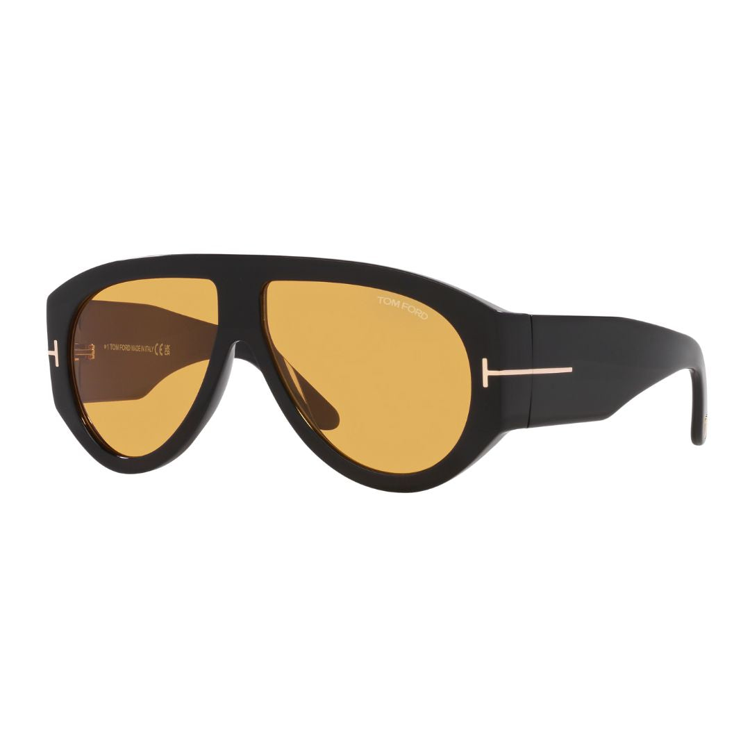 Tom Ford FT1044 sunglasses for men featuring a bold shiny black acetate pilot frame. The solid brown lenses are paired with the signature gold 'T' logo at the temples.