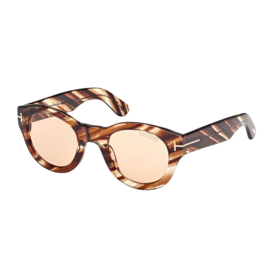Tom Ford FT1212 Lucinda unisex sunglasses featuring a unique Coloured Havana acetate round frame. The orange lenses create a vibrant contrast with the signature gold 'T' branding on the temples.