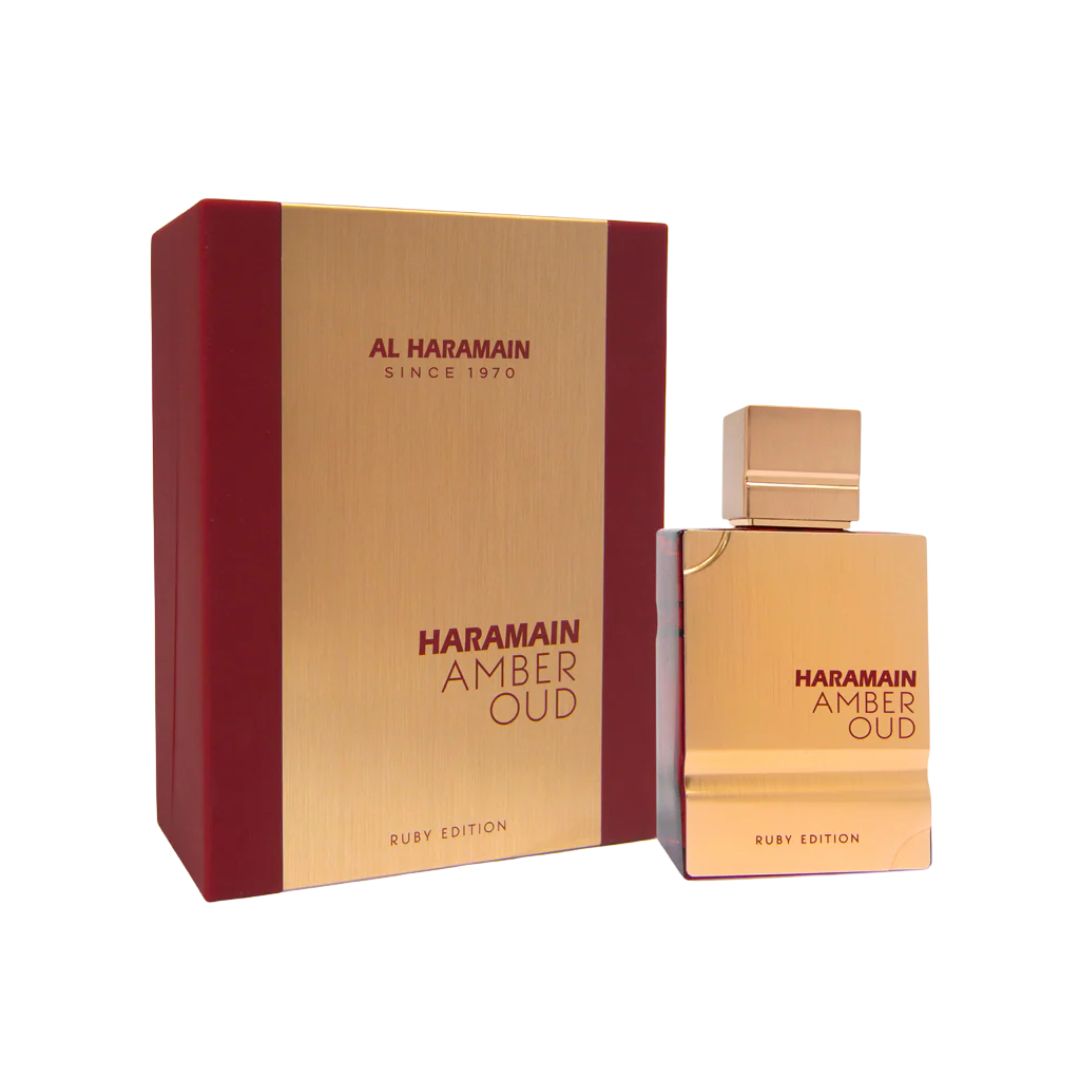 Al Haramain Amber Oud Ruby Edition EDP 60ml, a striking crimson-red and gold bottle, suggesting a rich, warm oriental scent with notes of bitter almond, saffron, and ambergris.