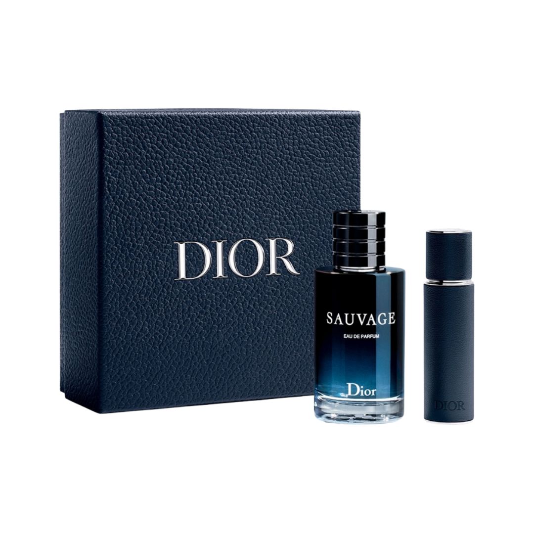 Dior Sauvage Eau de Parfum bottle with its matching navy blue textured box and a smaller matching travel spray bottle, all on a white background.
