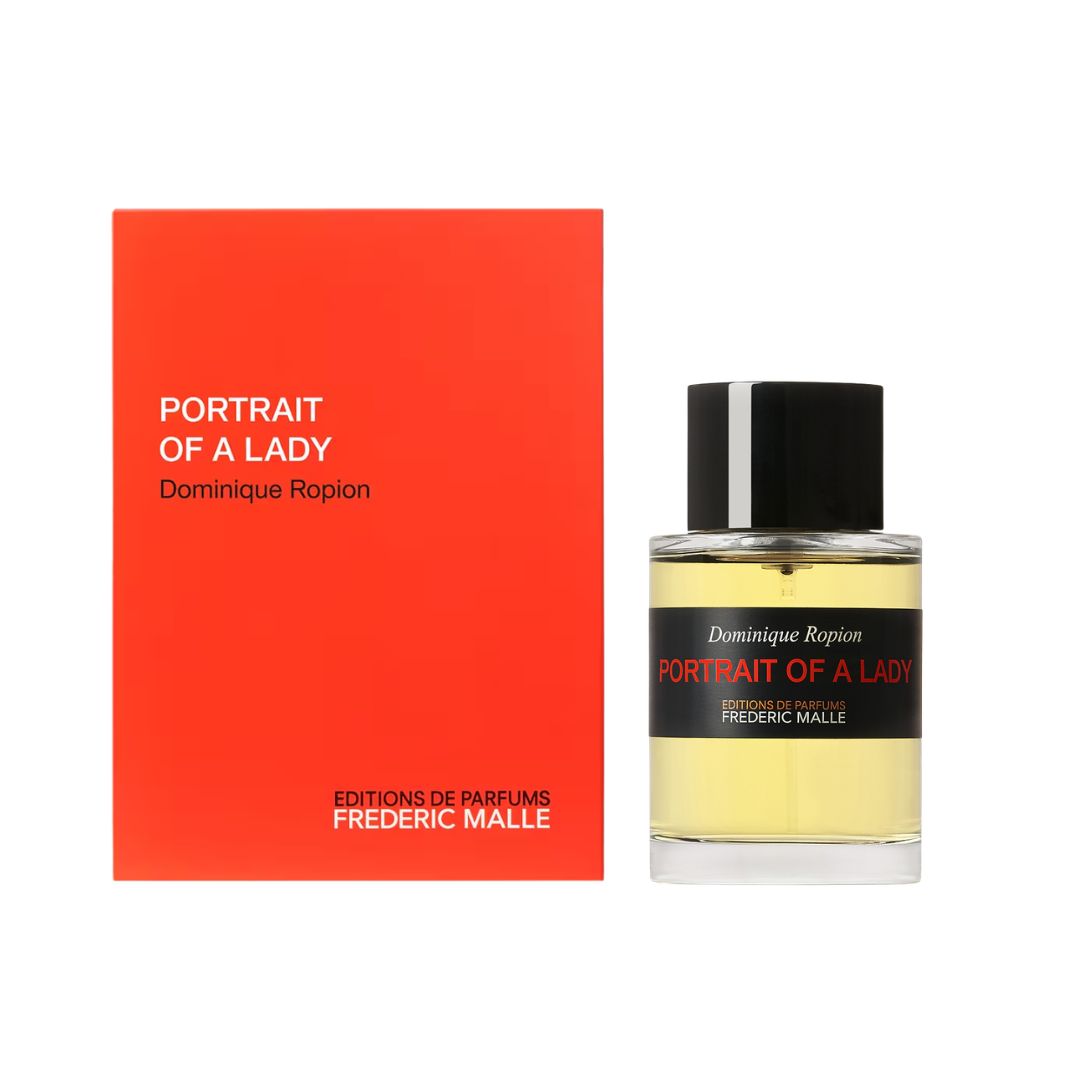 Portrait of a Lady perfume 100ml by Dominique Ropion, showing the bright orange-red box next to the clear glass bottle filled with pale yellow liquid and a black cap.