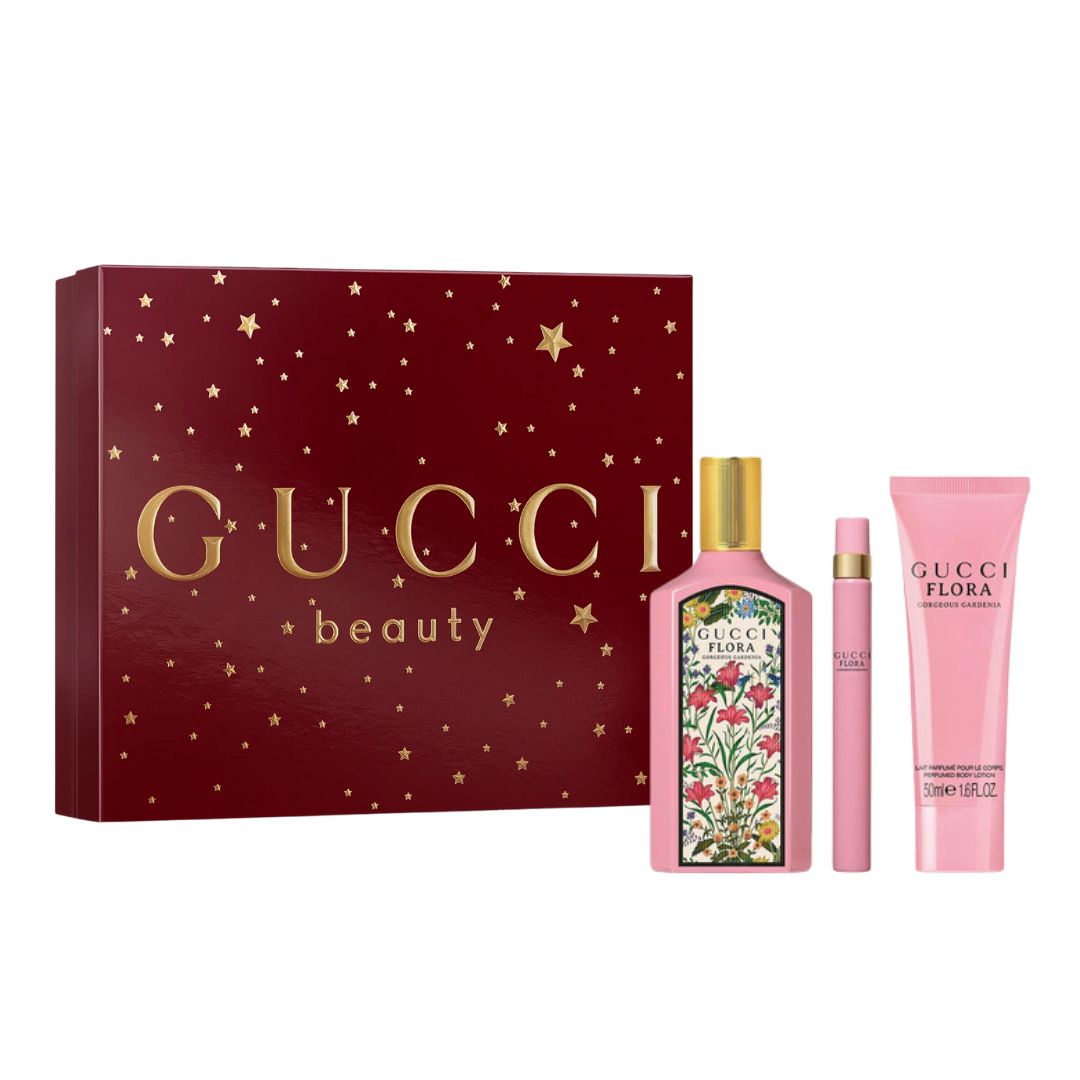 Gucci Flora Gorgeous Gardenia 3pc Gift Set, a vibrant pink and floral box containing the iconic pink 100ml bottle, a 10ml travel spray, and 50ml body lotion, suggesting a sweet, luminous, and rich gardenia floral scent.