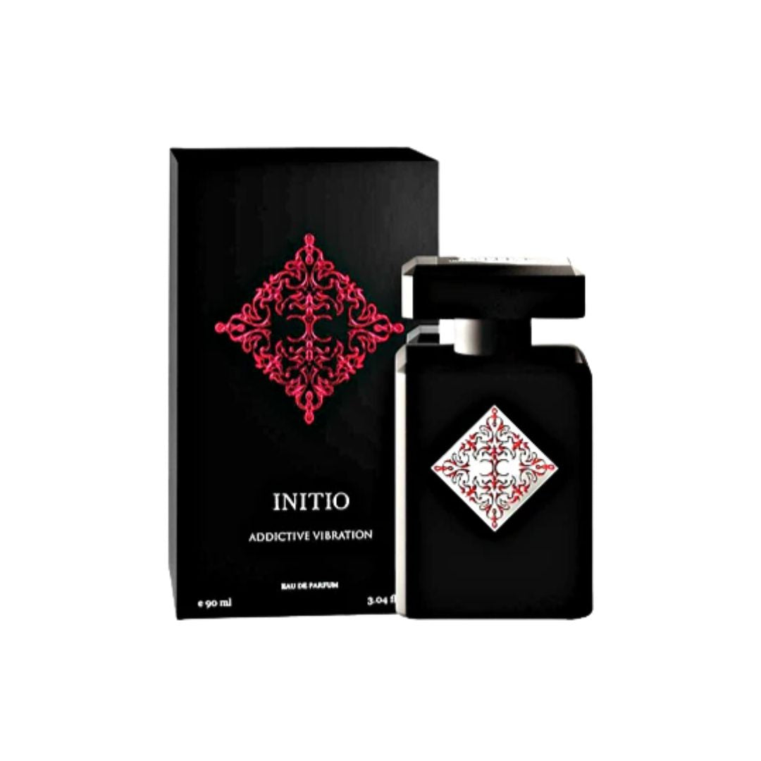 Initio Parfums Prives Addictive Vibration 90ml EDP, a sleek, dark bottle with an intricate gold geometric emblem, suggesting a sweet, luminous, and highly addictive unisex fragrance.
