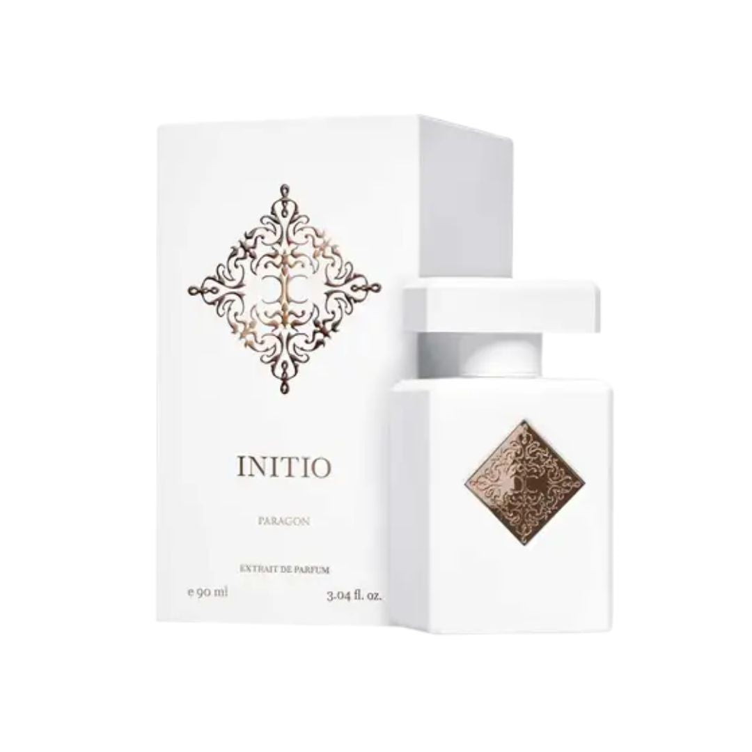 Initio Parfums Prives Paragon 90ml Extrait de Parfum, a sleek, dark bottle with an intricate gold geometric emblem, suggesting a powerful, spiritual, and woody aromatic fragrance.