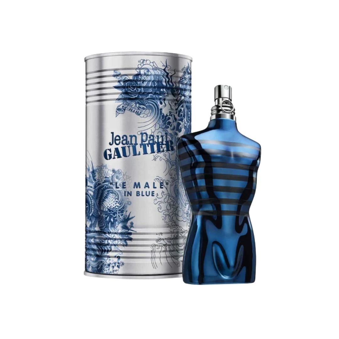 Jean Paul Gaultier Le Male In Blue cologne bottle and its matching cylindrical packaging box, both featuring a blue and white design, set against a plain white background.