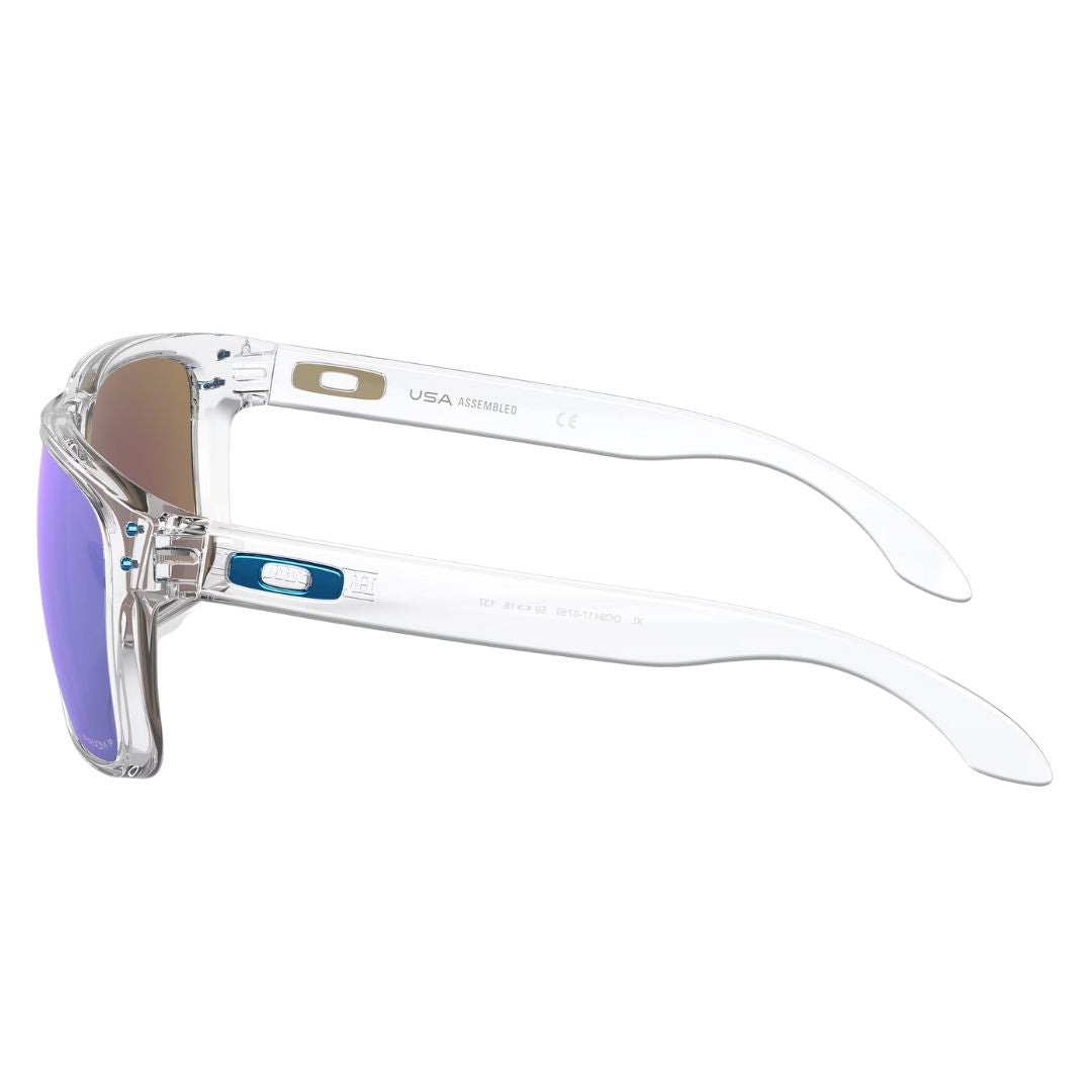 Side view of Oakley Holbrook XL clear sunglasses showing blue icon logo and metal rivets - Gadgets Online NZ