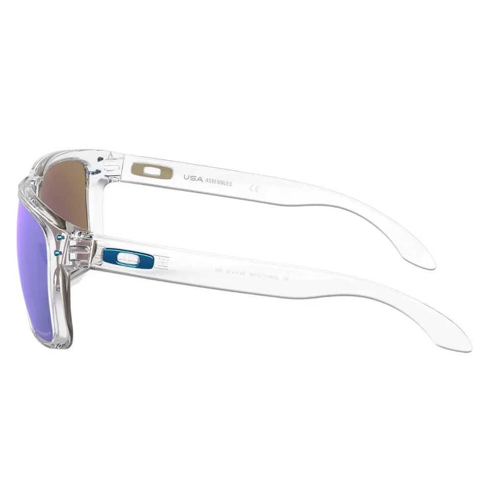 Side view of Oakley Holbrook XL clear sunglasses showing blue icon logo and metal rivets - Gadgets Online NZ