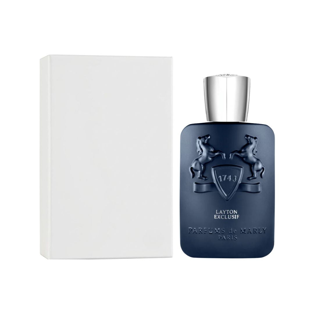 A bottle of Parfums de Marly Layton Exclusif EDP 125ml Tester fragrance in a dark navy blue bottle with a silver cap, shown next to its white rectangular box on a white background.