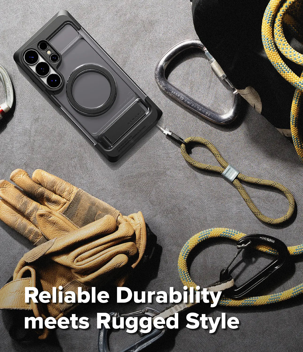 Phone case with carabiners and gloves on a gray surface, emphasizing durability and rugged style.