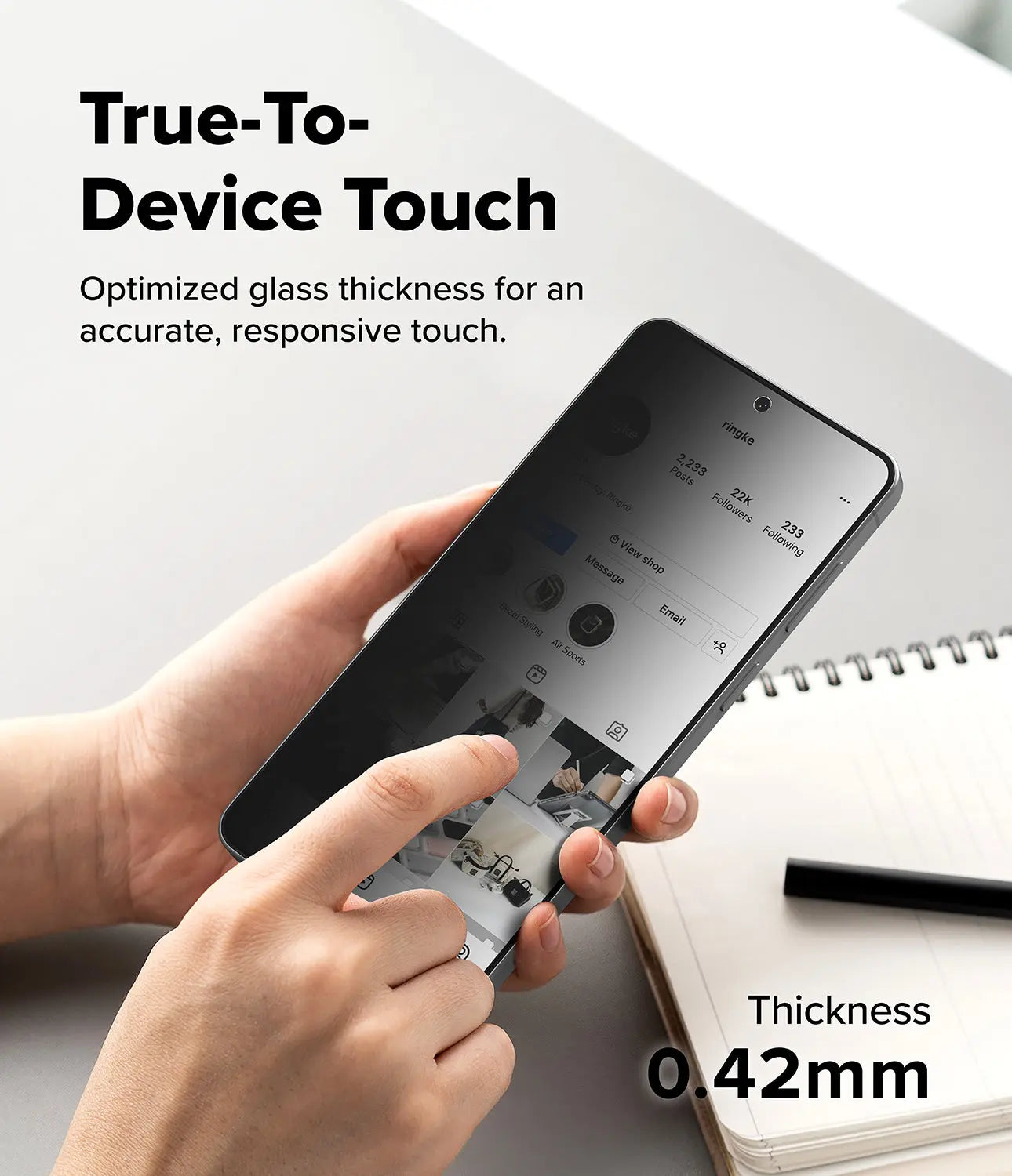 Person holding a smartphone with text about true-to-device touch and optimized glass thickness.