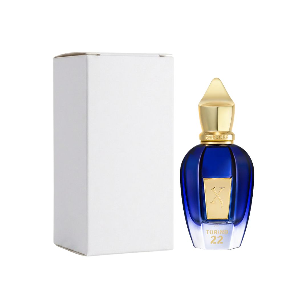 A bottle of Xerjoff Torino22 EDP 50ml Tester with a deep blue faceted glass body and a gold cap, shown next to its plain white box on a white background.