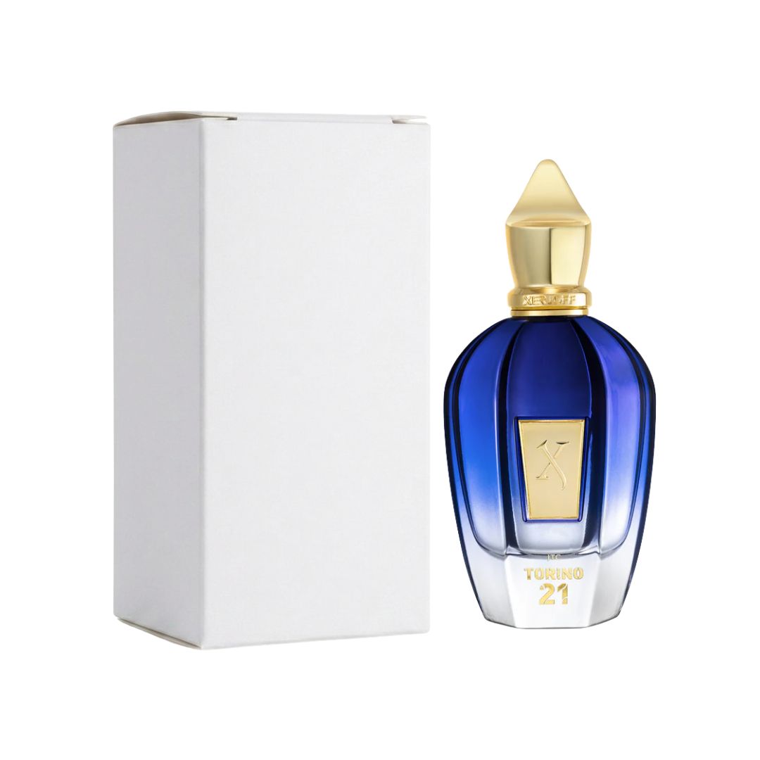 A bottle of Xerjoff Torino21 EDP 100ml Tester Eau de Parfum next to its white packaging box, featuring a deep blue gradient glass bottle with a gold cap and a gold emblem on the front.