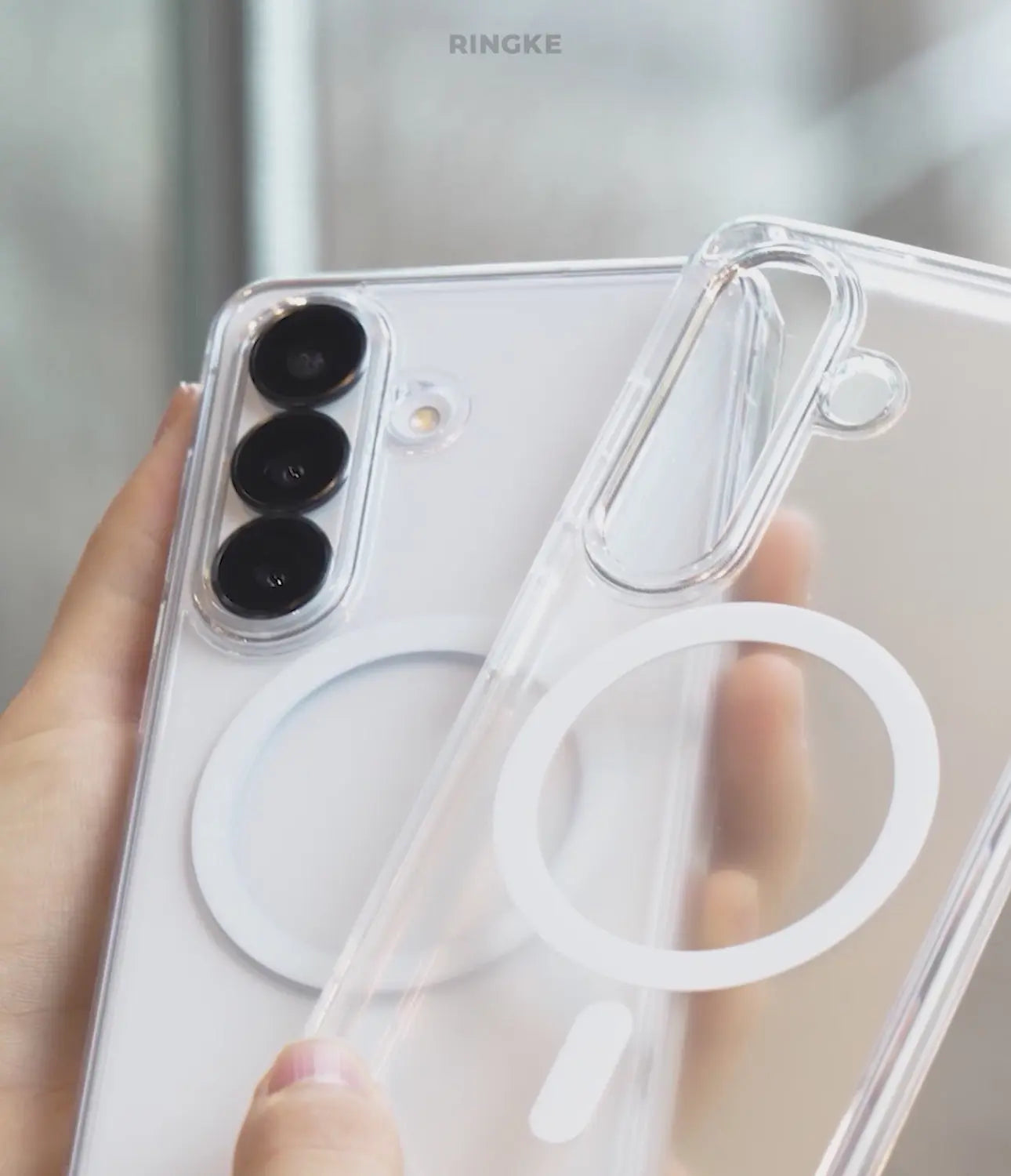 Clear phone case with brand logo held by a hand