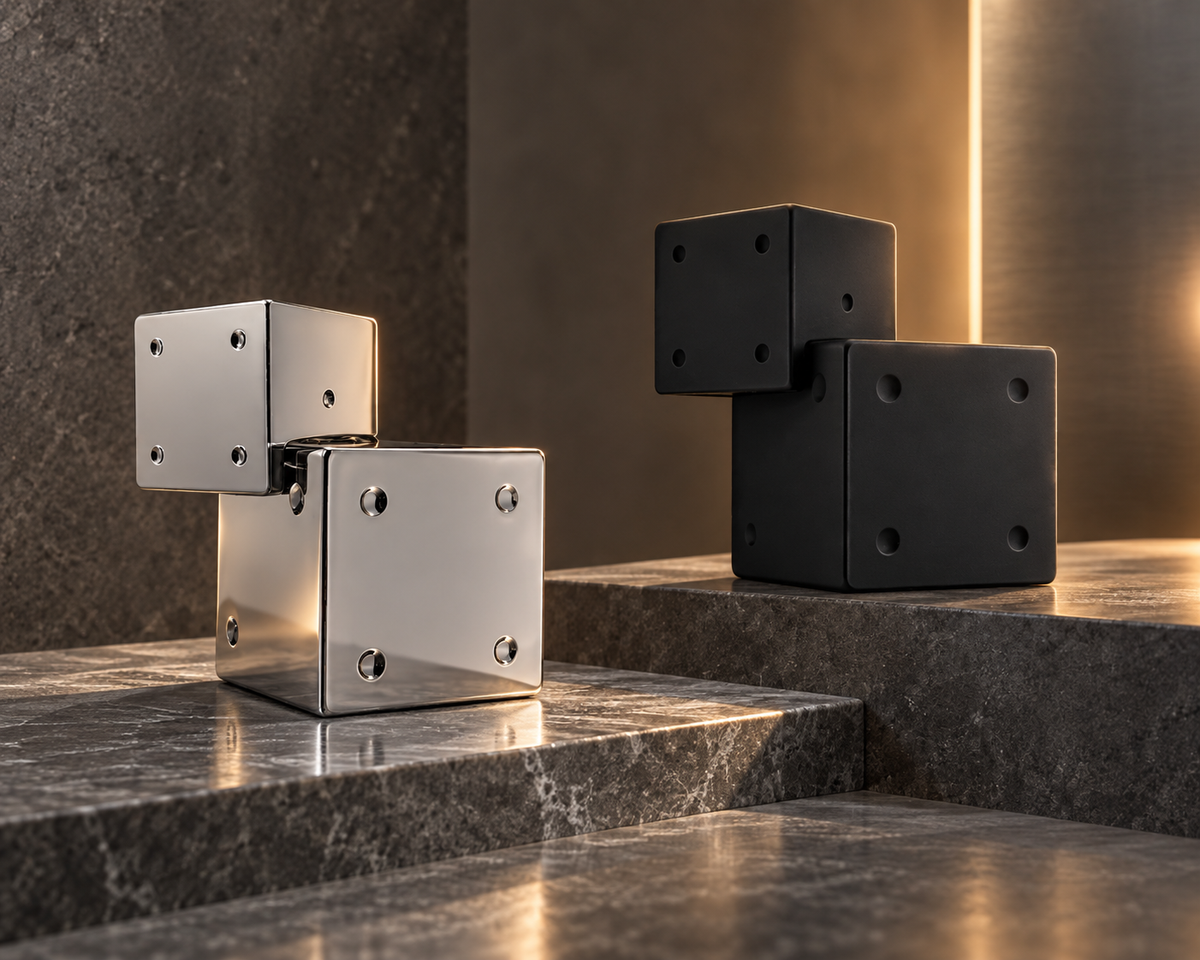 Billie Eilish Your Turn and Your Turn II geometric perfume bottles in polished silver and matte black on grey gallery stone.