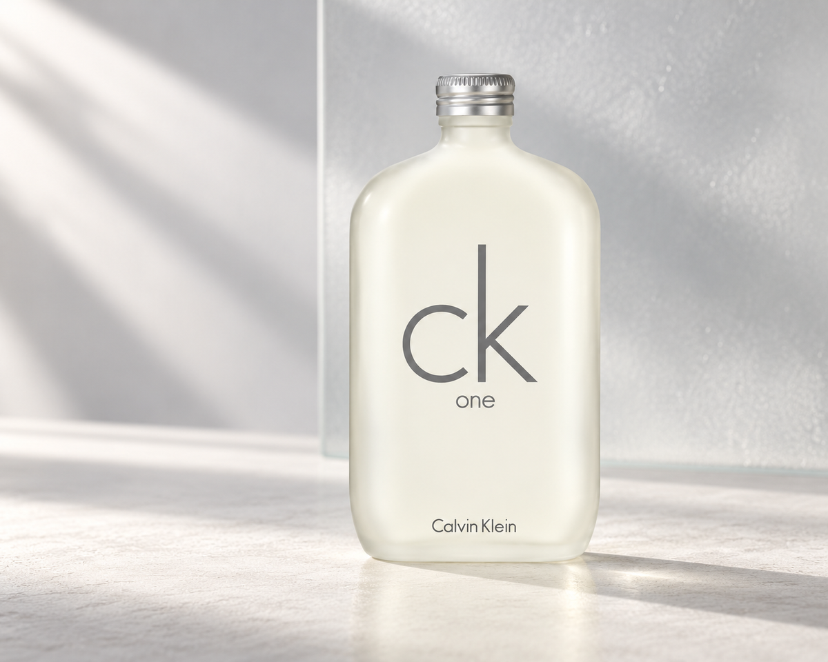 Calvin Klein CK One bottle in a clean, softly lit grey and frosted glass setting.