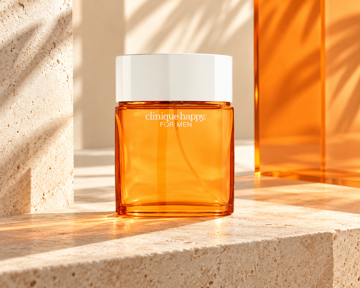 Clinique Happy for Men orange glass bottle in a sunlit ivory-and-tangerine modernist studio.