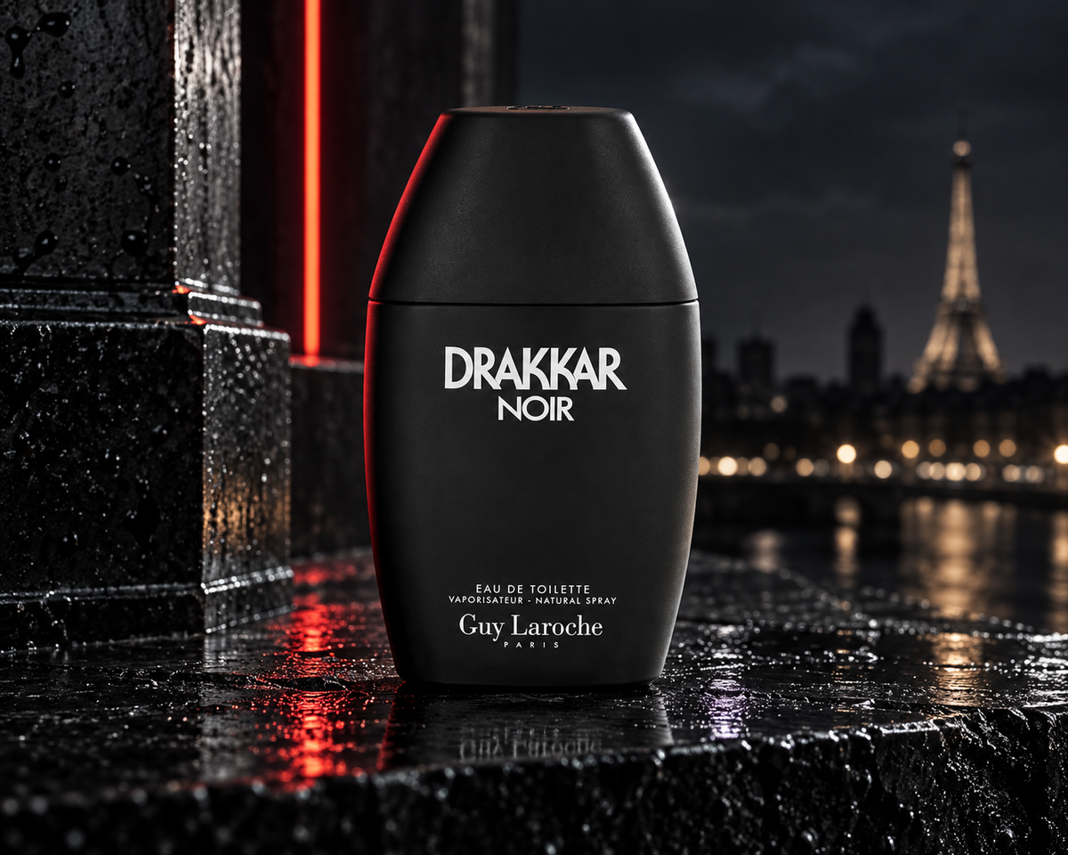 Guy Laroche Drakkar Noir matte-black bottle on rain-darkened stone with Paris night lights and a red architectural accent.