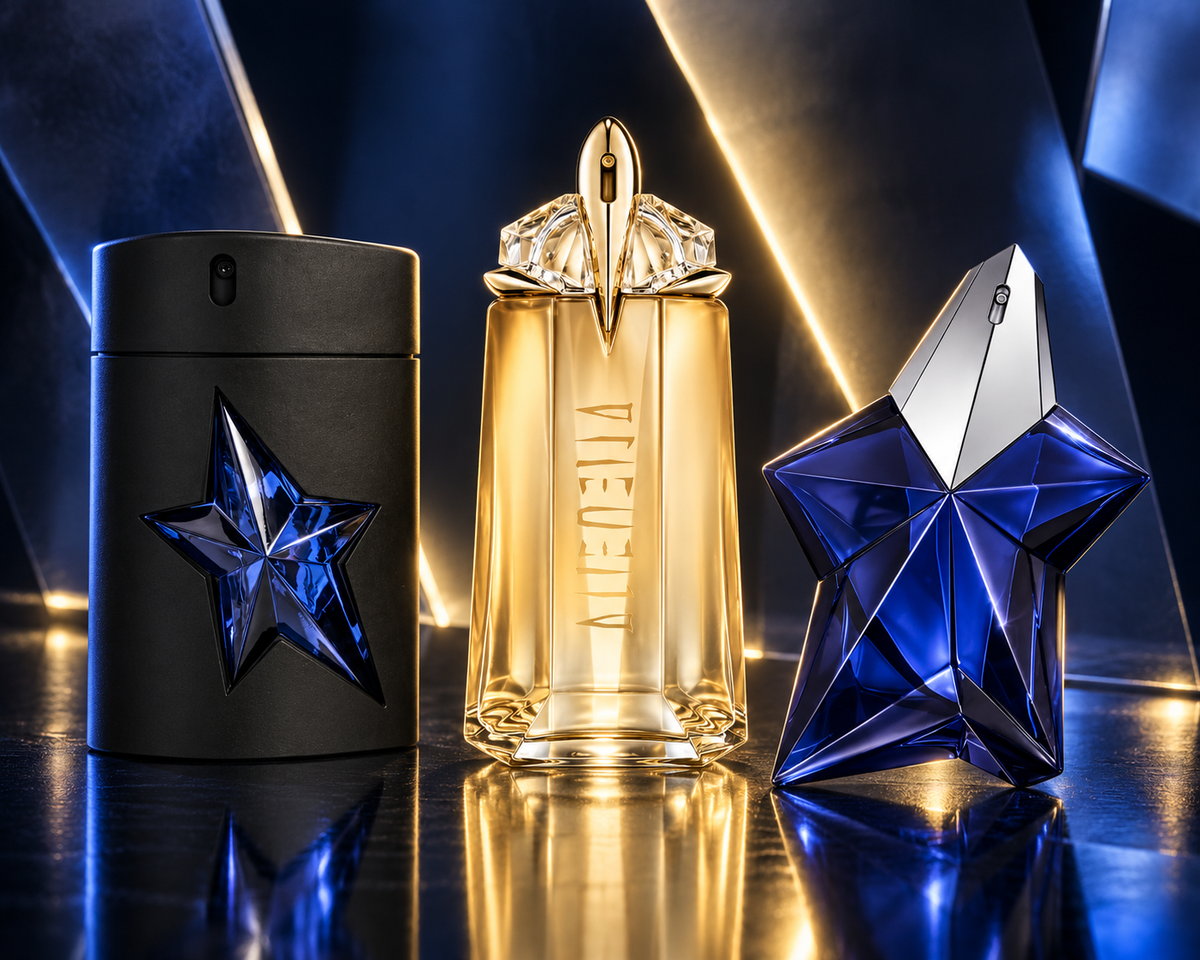 Mugler A*Men, Alien Goddess and Angel Elixir bottles in a midnight-blue setting with gold light and angular reflections.