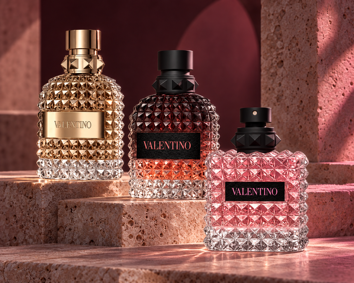 Valentino Uomo, Uomo Born In Roma Coral Fantasy and Donna Born In Roma bottles on rose travertine at dusk
